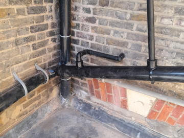 Photo: Connecting the toilet, sink and shower to the drain pipe.